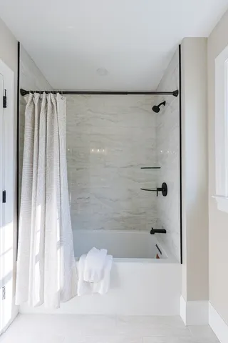 a bathroom with a bathtub and a shower