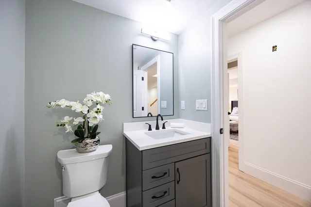 a bathroom with a sink vanity and a mirror