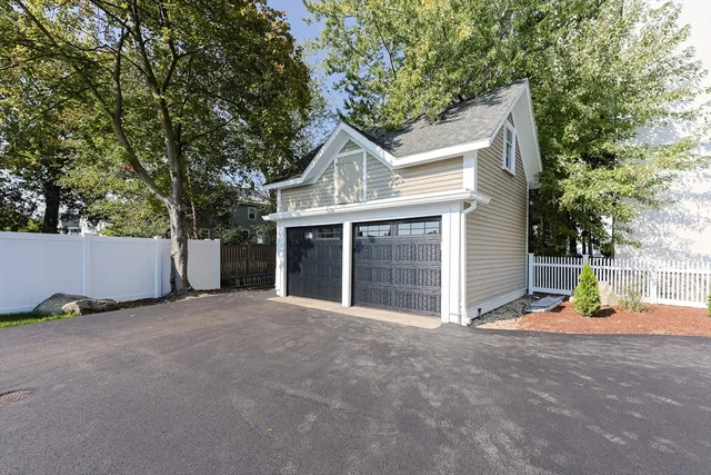 front view of a house with a yard and potted plants