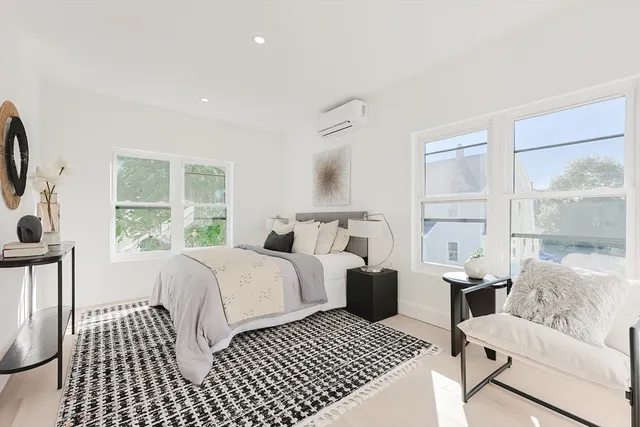 a bedroom with furniture and a window