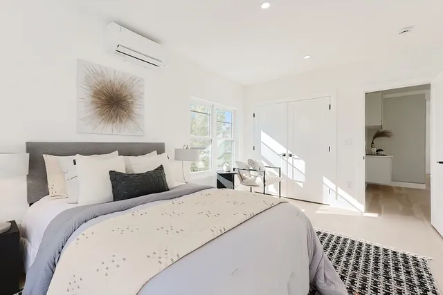 a bedroom with double bed and a window