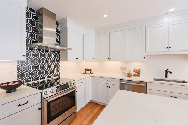 a kitchen with cabinets and appliances