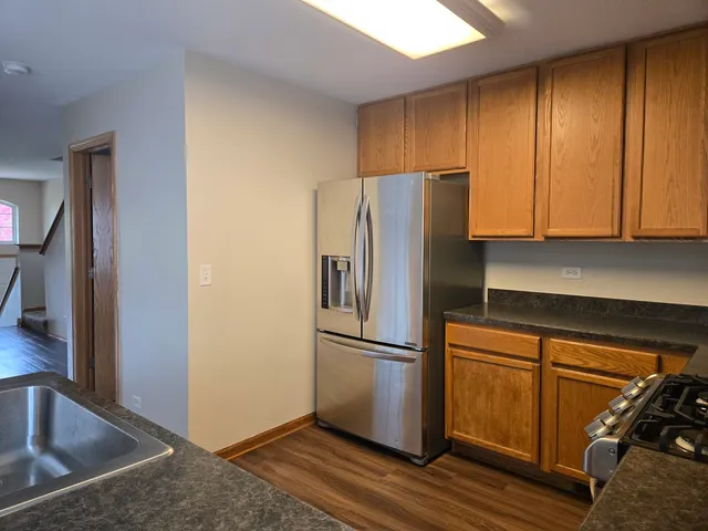 a kitchen with a refrigerator cabinet and a sink