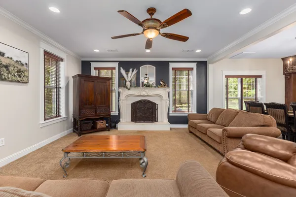 a living room with furniture flat screen tv and a fireplace