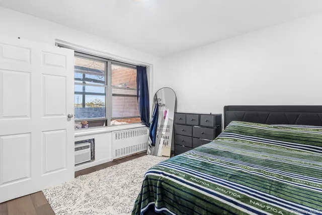 a bedroom with two beds and a dresser