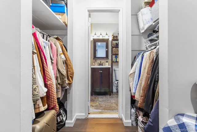 a view of walk in closet with clothes and shoes