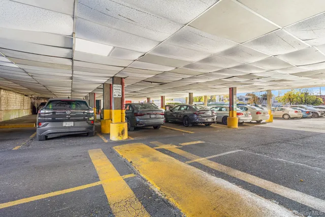 a view of parking garage with cars