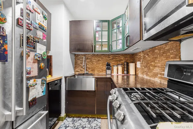 a kitchen with stainless steel appliances granite countertop a stove and a sink