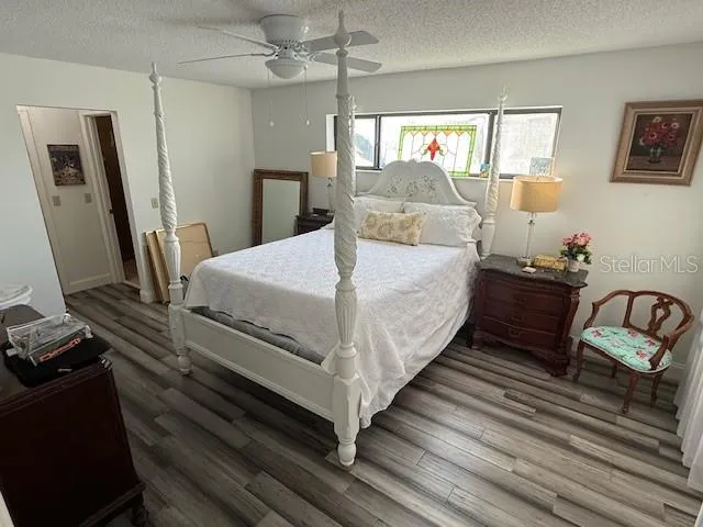 a bedroom with bed and wooden floor