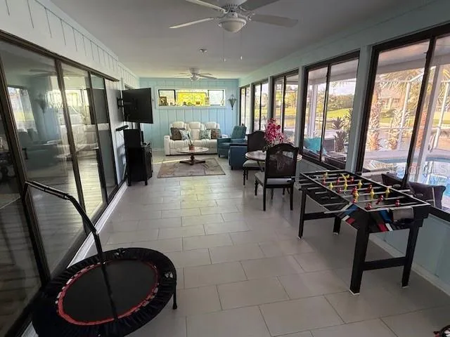 a living room with furniture a floor to ceiling window and a fireplace