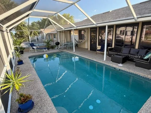 a view of a swimming pool with potted plants