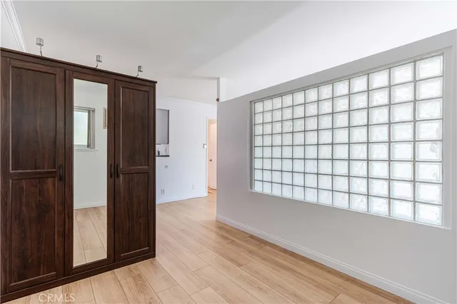 a view of wooden floor and windows in a room