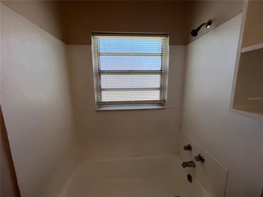 1339 Winnifred Street Orlando, FL 32805 - Photo 11 of 13 a bathroom with a bathtub