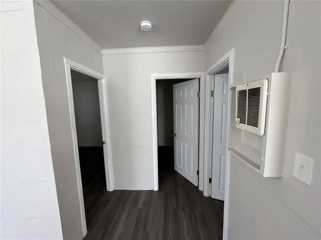a view of a hallway with wooden floor