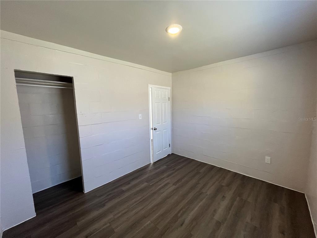 1339 Winnifred Street Orlando, FL 32805 - Photo 9 of 13 an empty room with wooden floor and closet