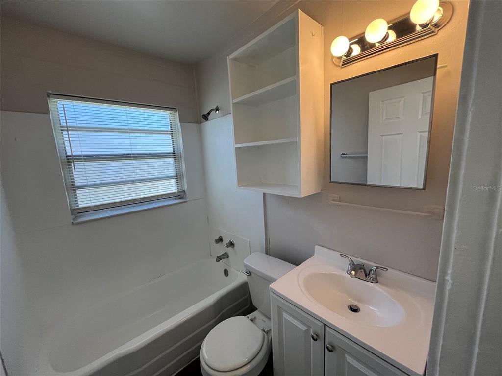 1339 Winnifred Street Orlando, FL 32805 - Photo 10 of 13 a bathroom with a sink vanity mirror and toilet