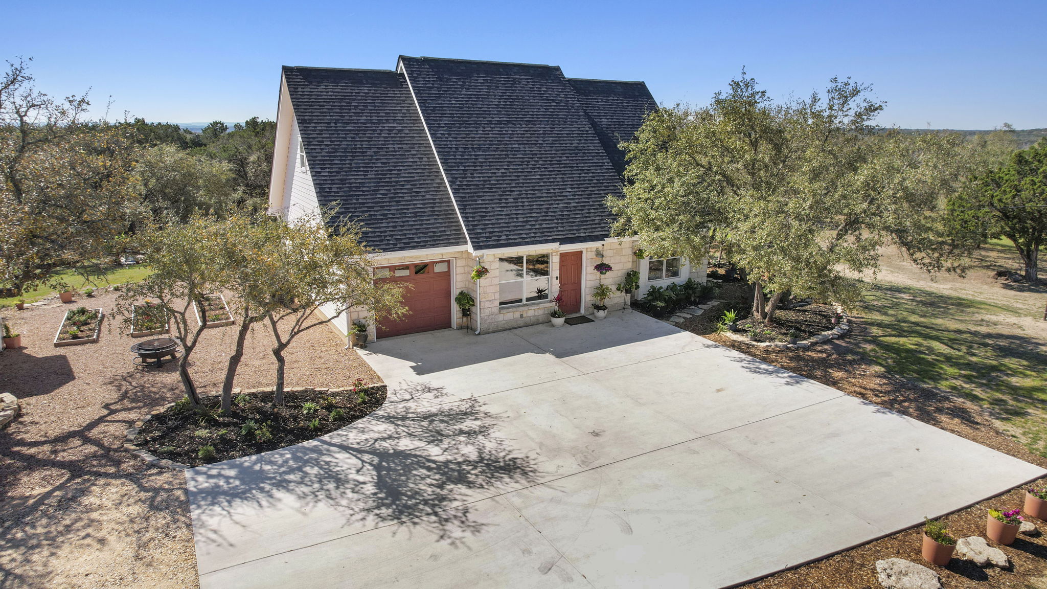 7197 Mt Sharp Road Wimberley, TX 78676 - Photo 1 of 1 View of front of property with concrete driveway and roof with shingles