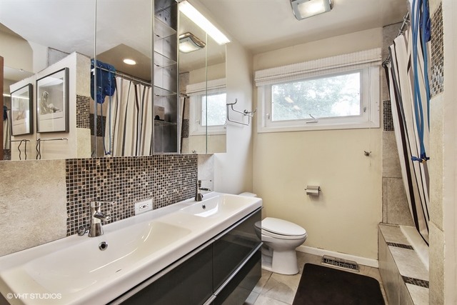 1190 Ridge Road Highland Park, IL 60035 - Photo 8 of 13 a bathroom with a sink a toilet and shower