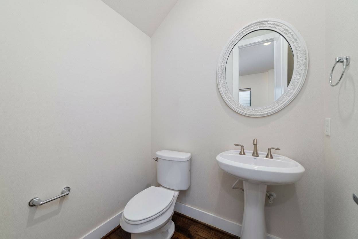 1917 West 15th Street, Unit A Houston, TX 77008 - Photo 15 of 34 a bathroom with a toilet a sink and a mirror