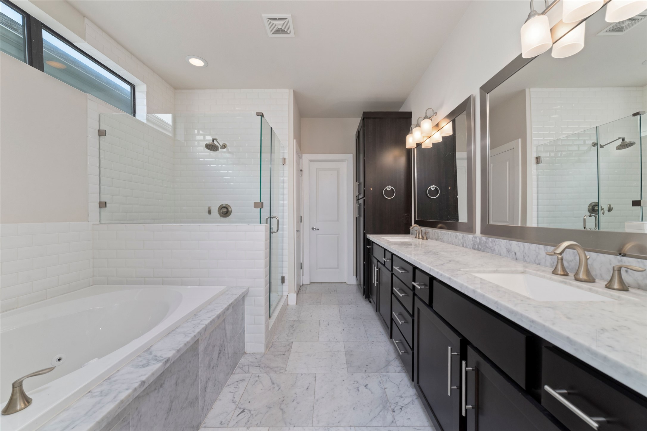 1917 West 15th Street, Unit A Houston, TX 77008 - Photo 20 of 34 a bathroom with a granite countertop double vanity sink a mirror and a bathtub