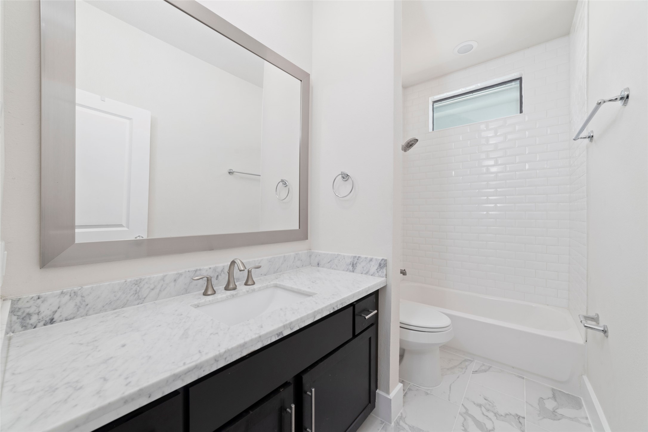 1917 West 15th Street, Unit A Houston, TX 77008 - Photo 23 of 34 a bathroom with a granite countertop sink a toilet and shower