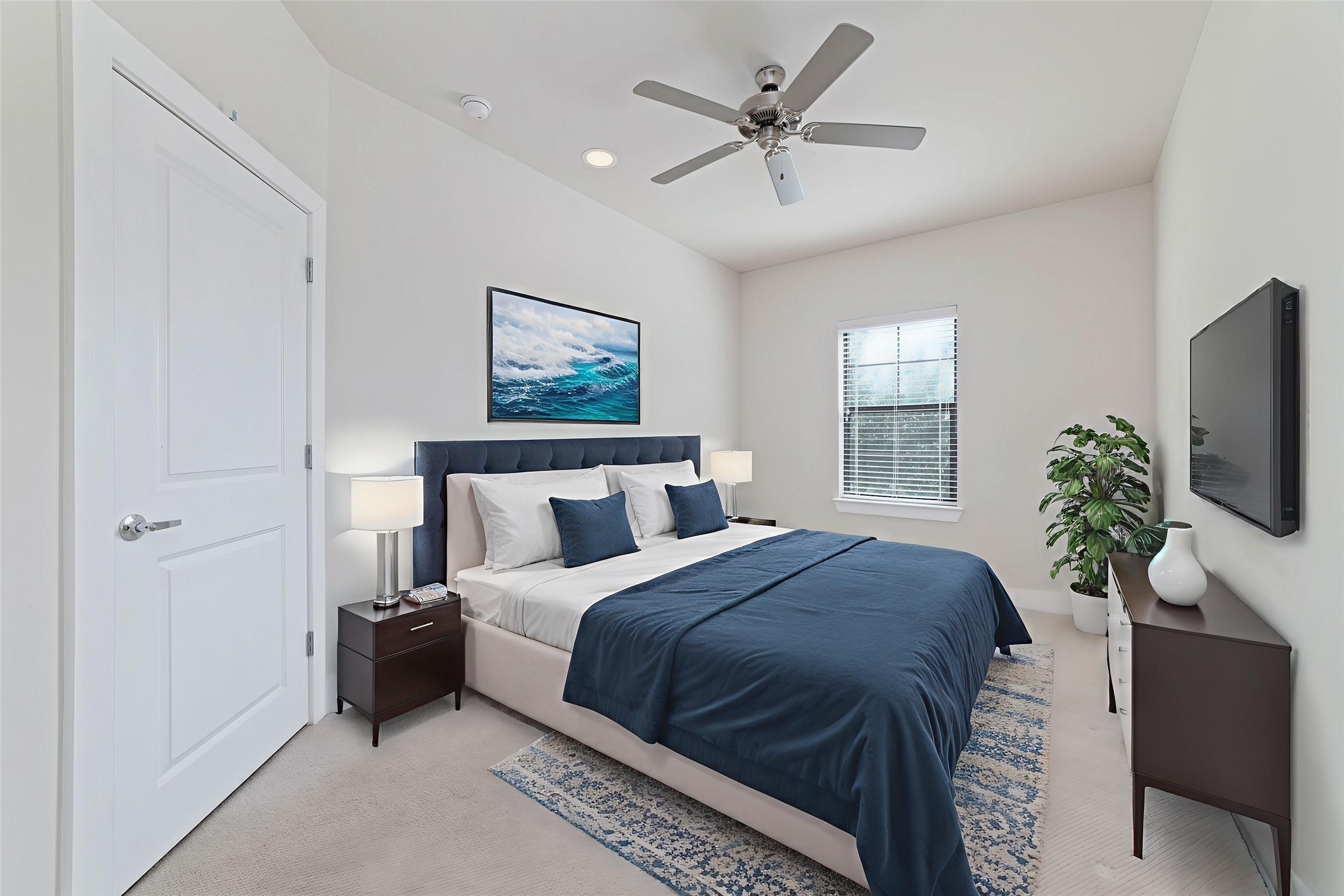 1917 West 15th Street, Unit A Houston, TX 77008 - Photo 27 of 34 a spacious bedroom with a large bed a flat tv screen and a potted plant