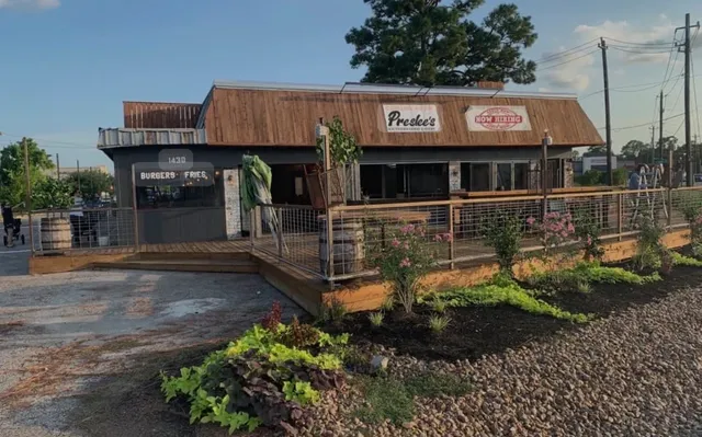 a front view of a building with table and chairs