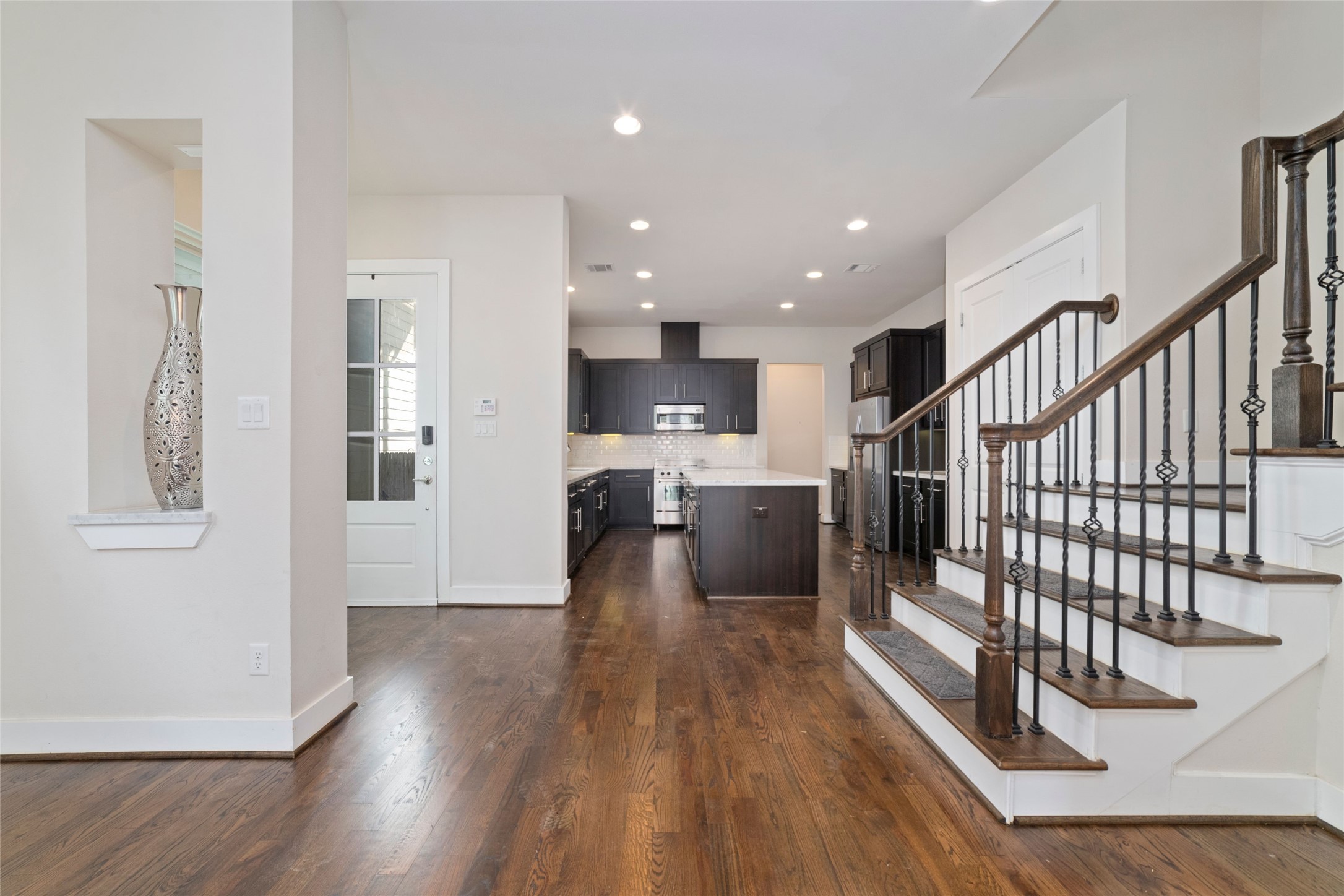 1917 West 15th Street, Unit A Houston, TX 77008 - Photo 9 of 34 a view of a kitchen with wooden floor and electronic appliances