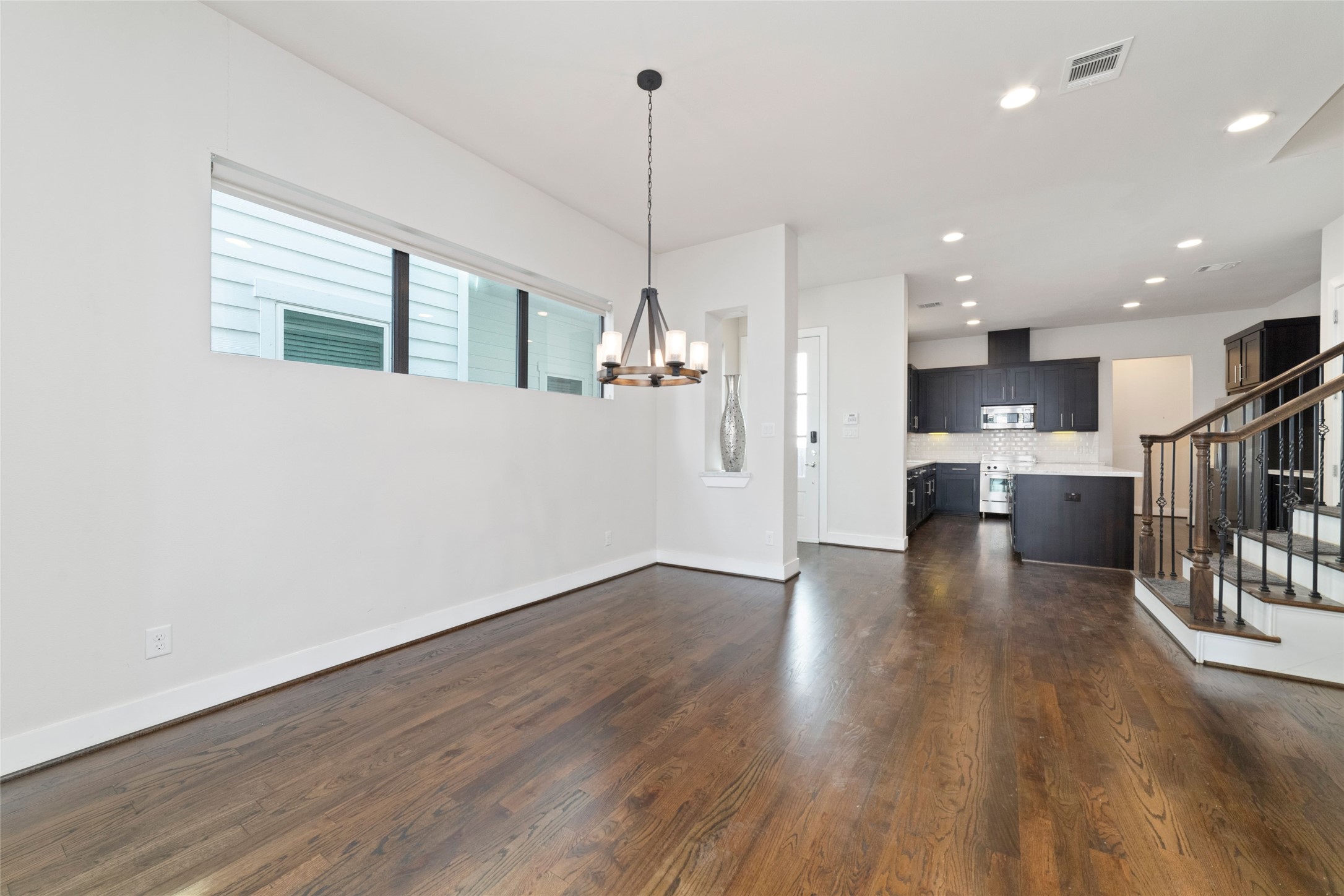 1917 West 15th Street, Unit A Houston, TX 77008 - Photo 10 of 34 a view of open kitchen with wooden floor and windows