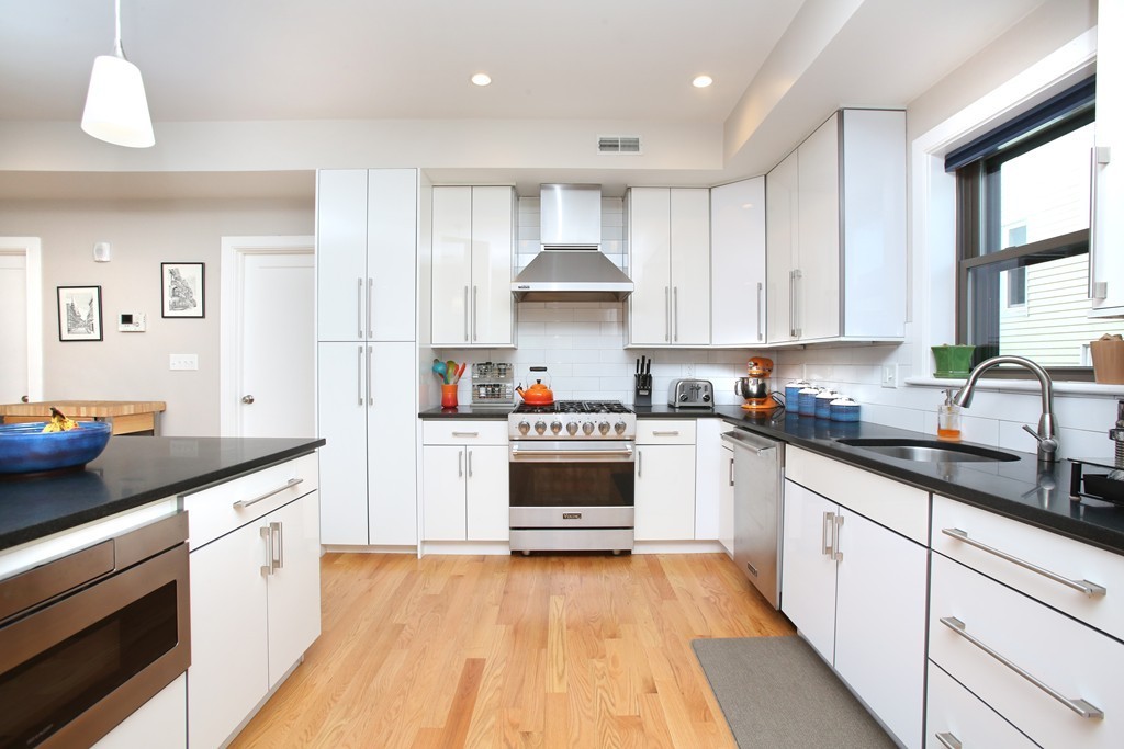 a kitchen with a white cabinets and white appliances