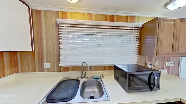 a kitchen with a sink and a stove top oven