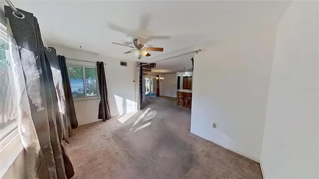 a view of a hallway with furniture and a window