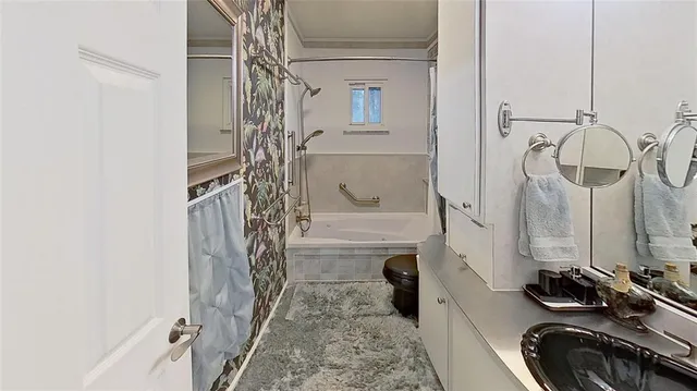 a bathroom with a bathtub and a shower