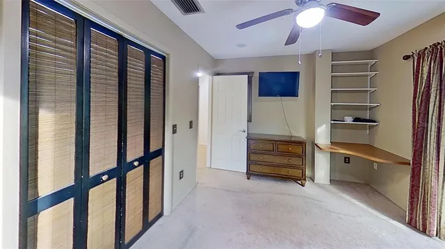 a view of a patio with table and chairs under an umbrella
