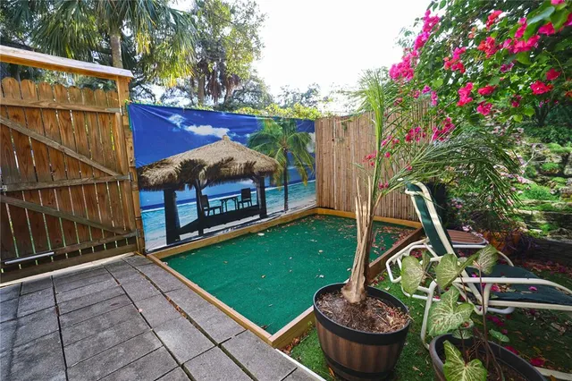 a view of a backyard with sitting area