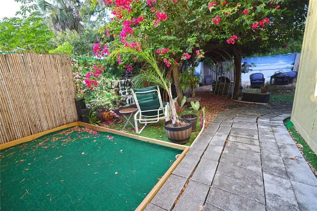 a backyard view with a seating space