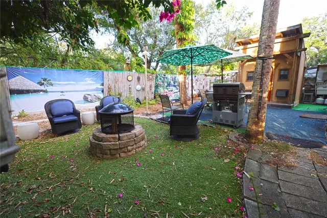 a view of a house with backyard sitting area and garden