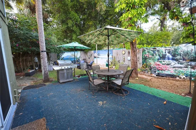 a patio with a yard table and chairs