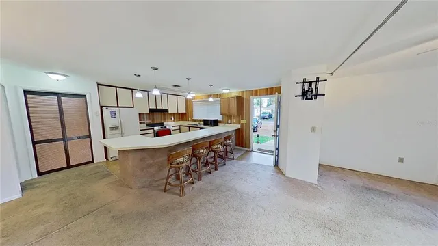 a kitchen with stainless steel appliances a refrigerator and a stove top oven