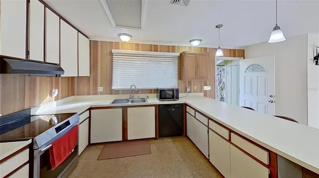 a kitchen with a sink stove and cabinets