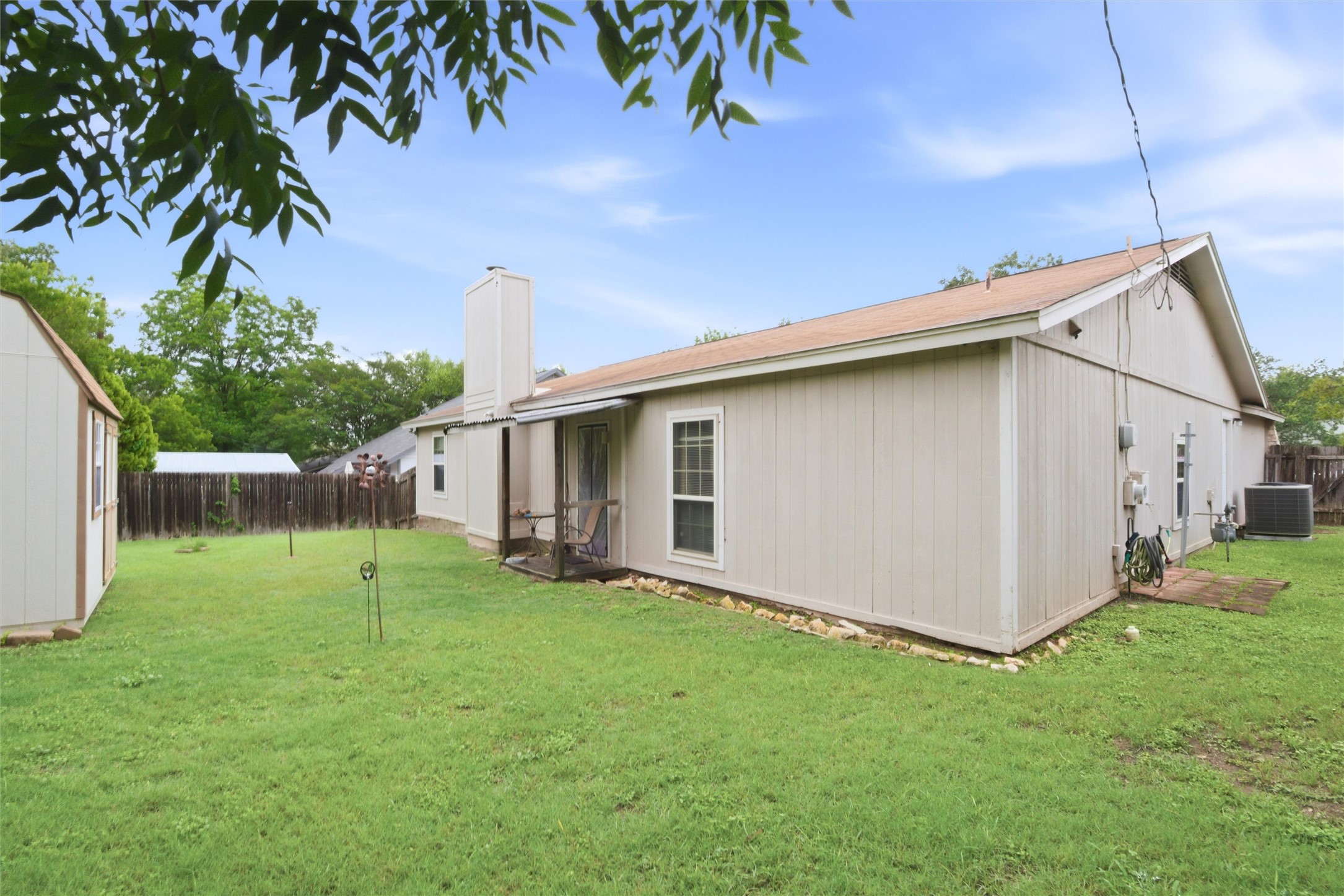 2000 Magazine Street Austin, TX 78727 - Photo 27 of 30 A spacious backyard with mature trees and a detached shed provides ample outdoor living space.
