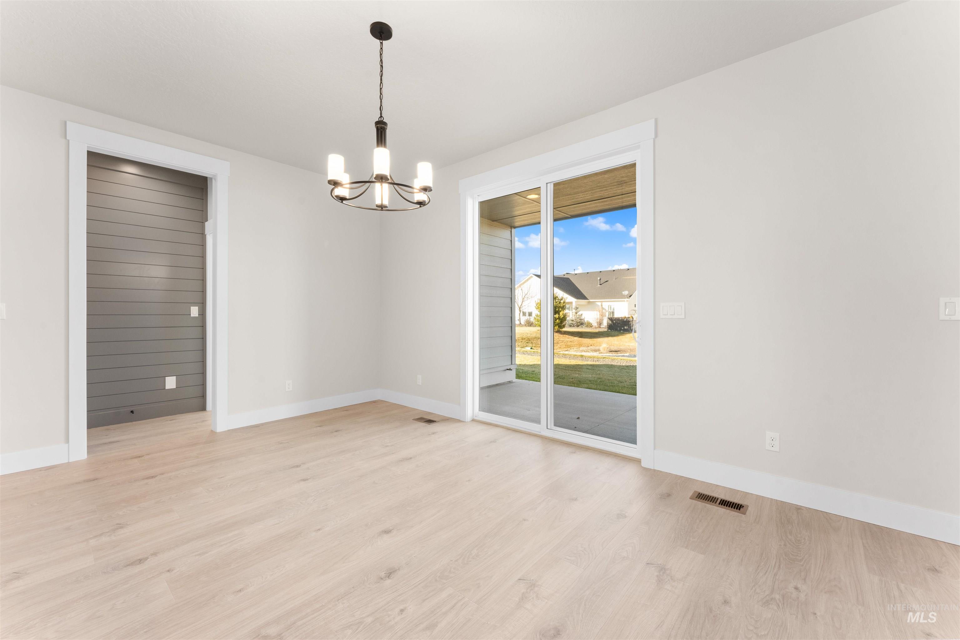 8076 Tandy Cv Street Middleton, ID 83644 - Photo 13 of 41 Unfurnished dining area with suspended lighting and light wood finished floors