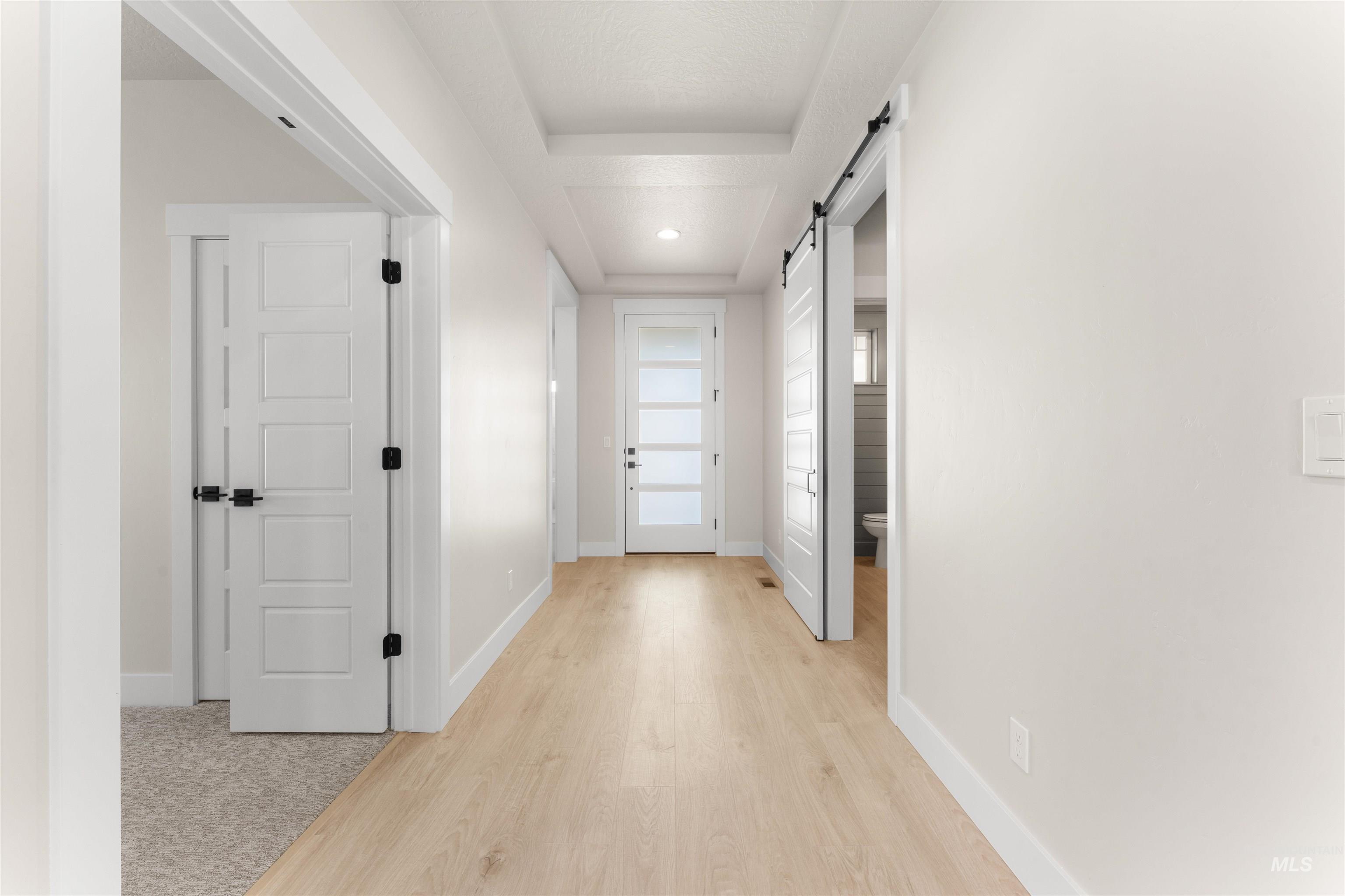 8076 Tandy Cv Street Middleton, ID 83644 - Photo 15 of 41 Hallway with a barn door and light wood-style floors