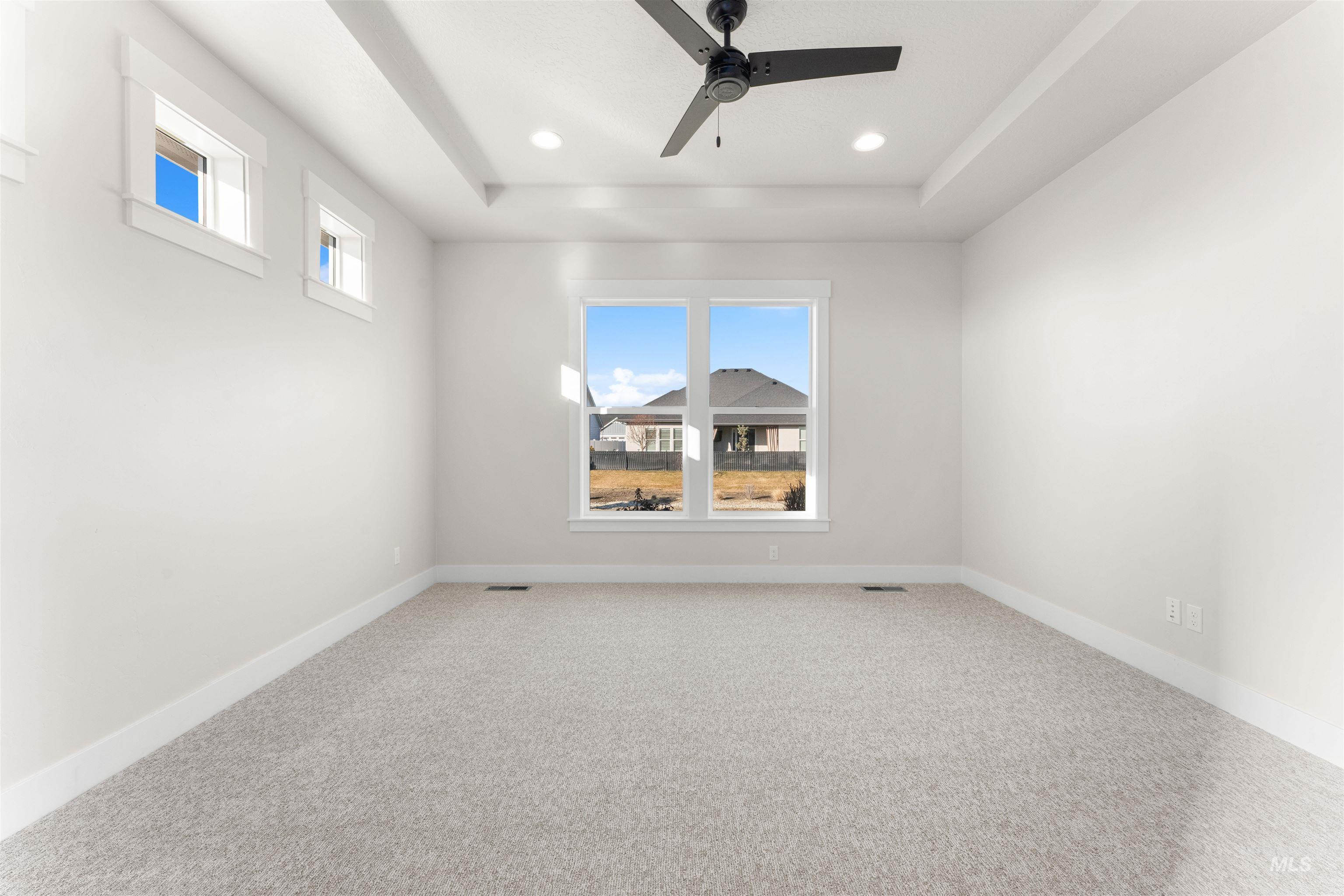 8076 Tandy Cv Street Middleton, ID 83644 - Photo 18 of 41 Unfurnished room with a tray ceiling, carpet floors, a ceiling fan, and recessed lighting