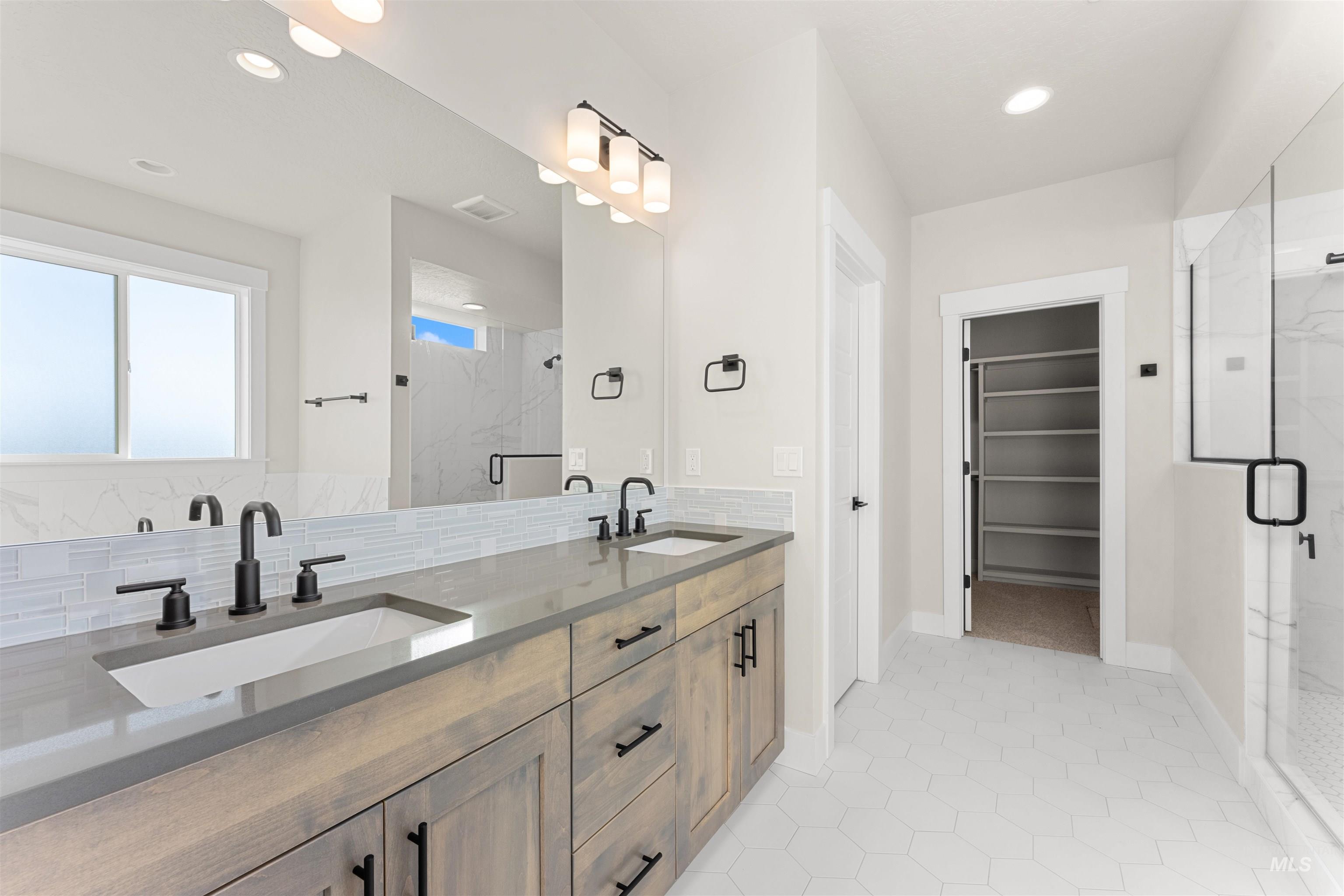 8076 Tandy Cv Street Middleton, ID 83644 - Photo 20 of 41 Full bathroom featuring double vanity, tasteful backsplash, a marble finish shower, a spacious closet, and recessed lighting