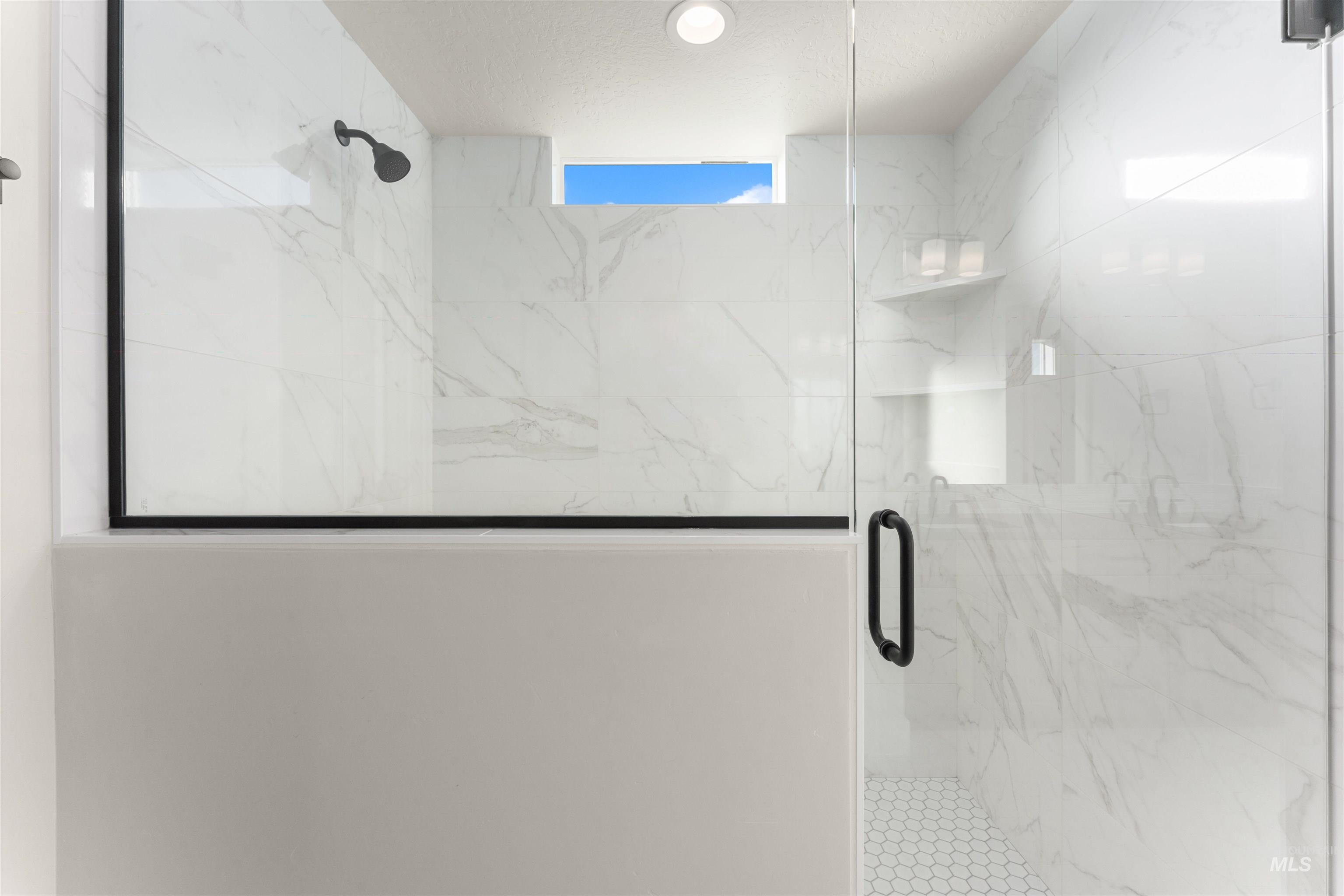 8076 Tandy Cv Street Middleton, ID 83644 - Photo 23 of 41 Bathroom with a marble finish shower and a textured ceiling