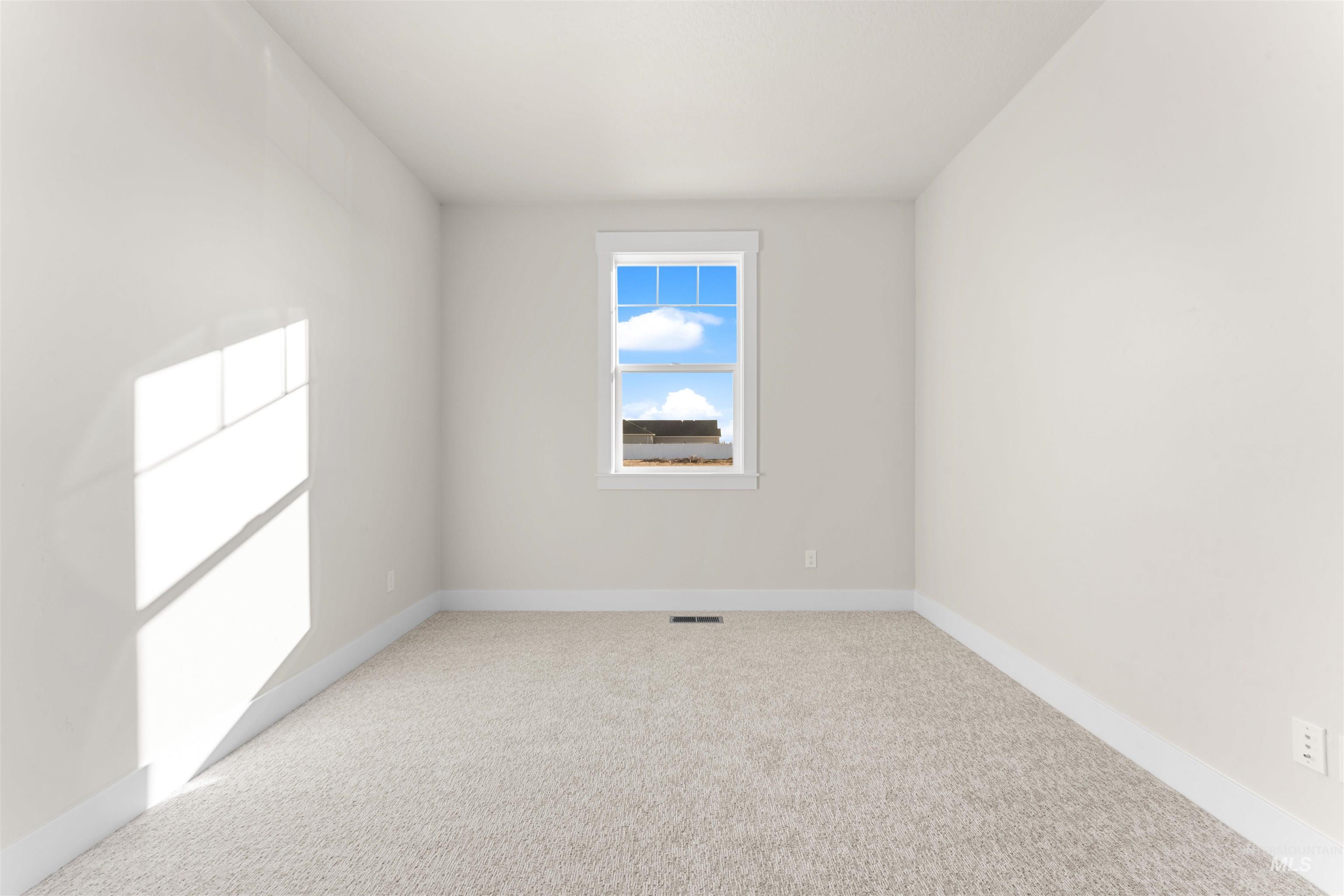 8076 Tandy Cv Street Middleton, ID 83644 - Photo 26 of 41 Spare room featuring light carpet and baseboards