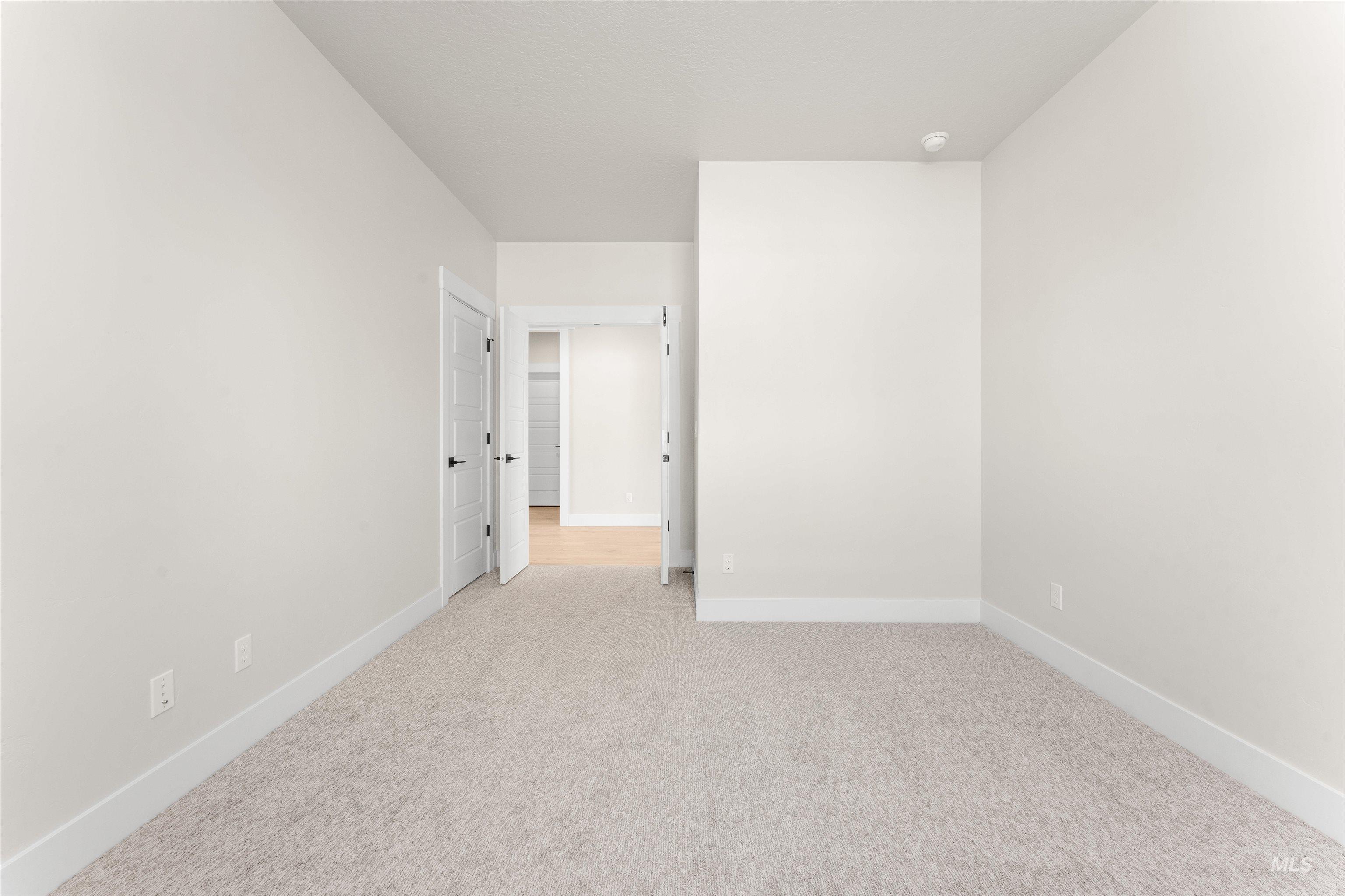 8076 Tandy Cv Street Middleton, ID 83644 - Photo 32 of 41 Unfurnished room featuring baseboards and light carpet