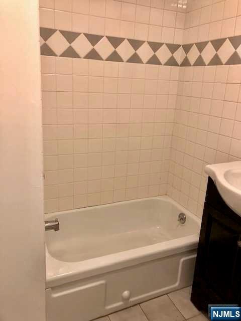 21 Columbus Street Bloomfield, NJ 07003 - Photo 9 of 20 a bathroom with a bathtub and a shower
