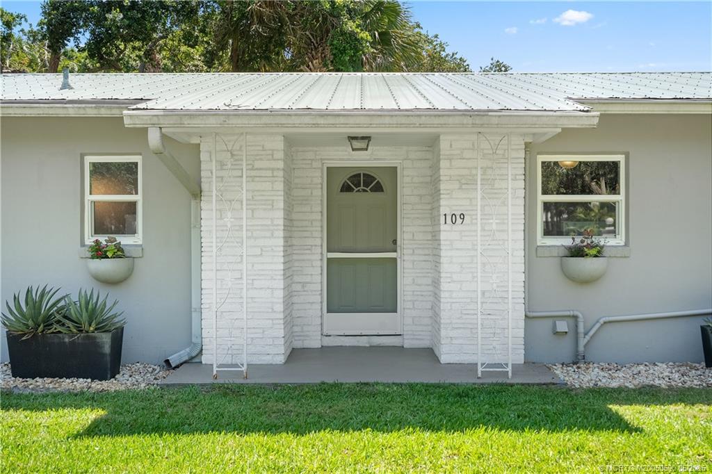 109 North Sewalls Point Road Stuart, FL 34996 - Photo 2 of 33 a front view of a house with a yard